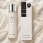 TirTir Milk Toner on silk and pearl backdrop.